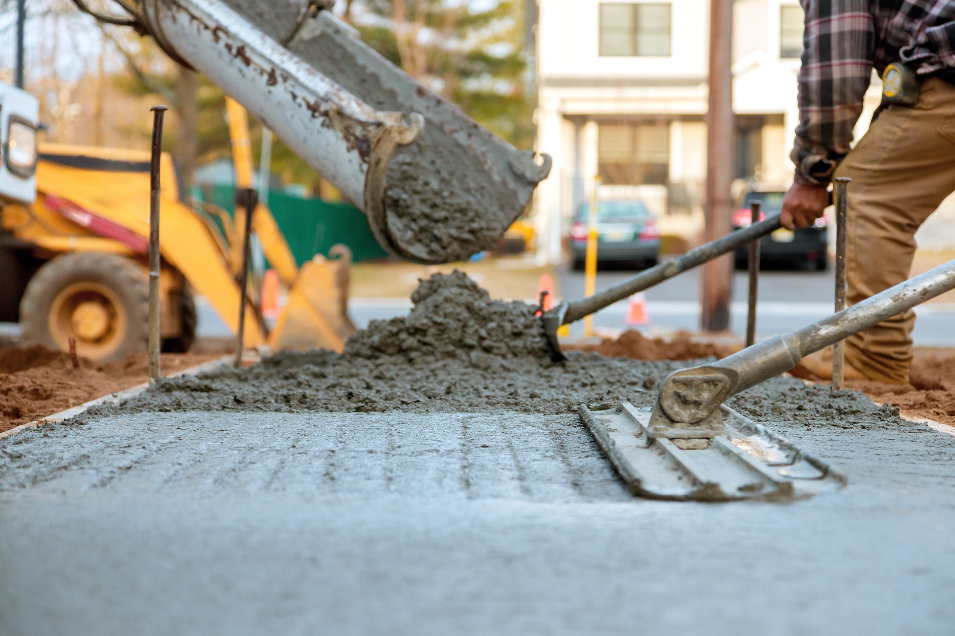 Concrete pouring process in urban area during daylight for new sidewalk installation